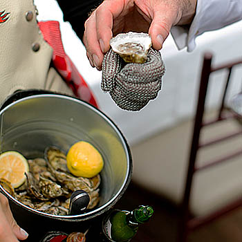 Our roving Oyster Caddies will fresh shuck oysters for you at your table