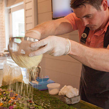 Joey Ward garnishing his dish for Flying Foods