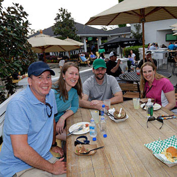 Guests enjoy a snack around a table on the Magnolia Deck